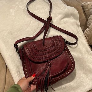 Maroon crossbody saddle bag, lightly worn, adjustable strap, multiple pockets